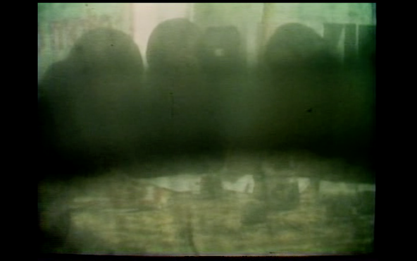 Image 2- Film still from _Underground_ with faces of members of the Weather Underground obscured.png